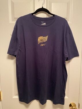 Reebok Navy Short Sleeve Tee with Gold Flag Logo…size L